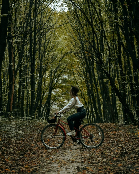 a person sitting on a bike on a trail