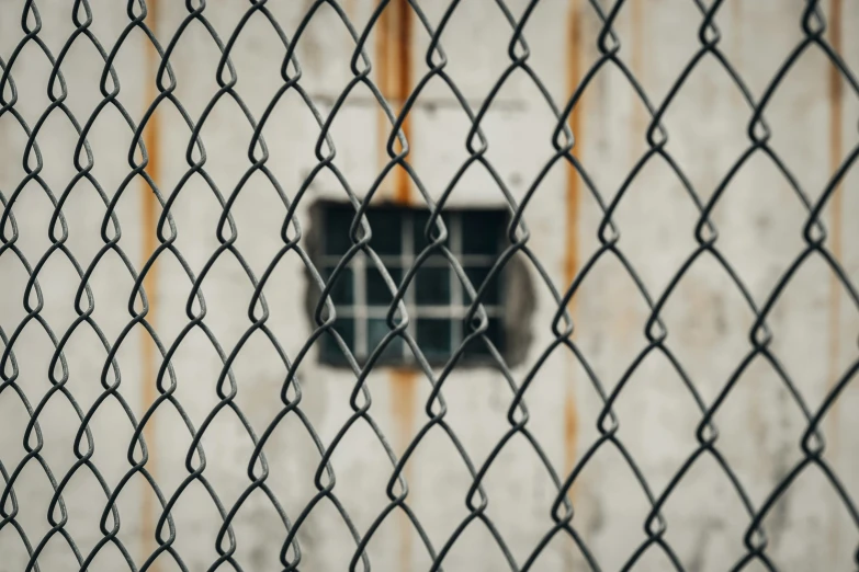 metal and chain linked fence on the side of a building