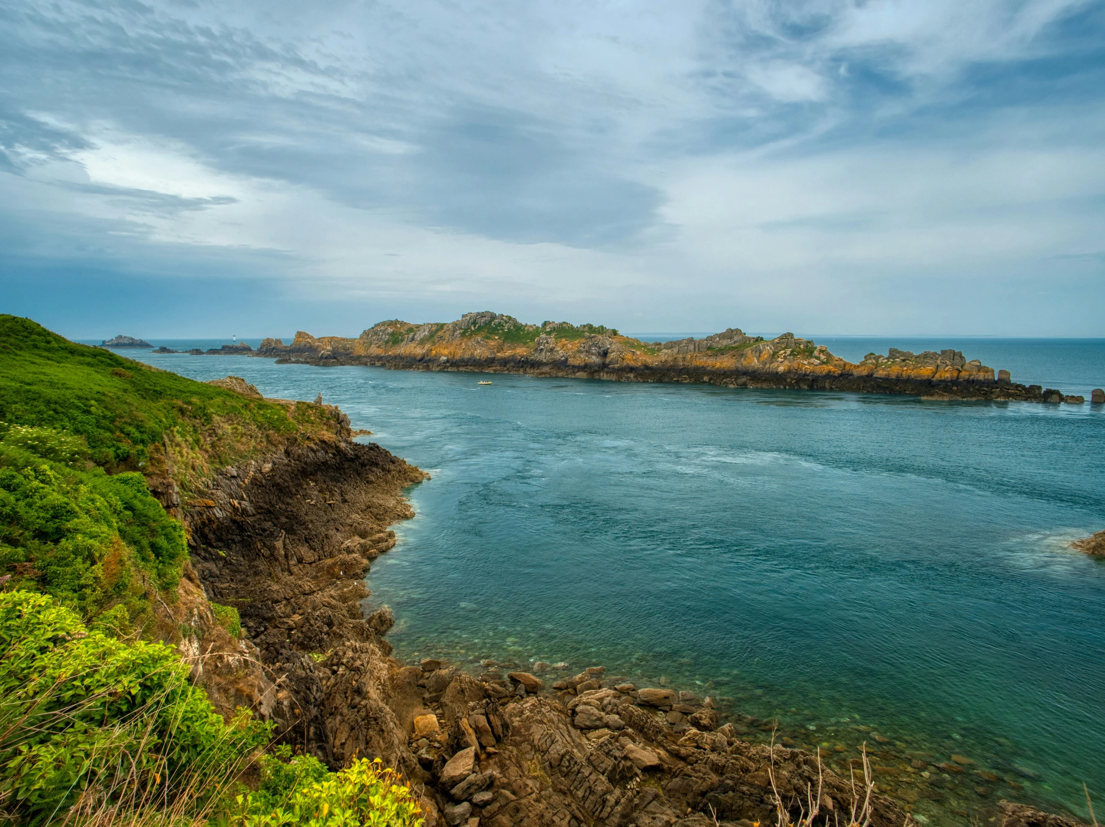 a body of water sitting between two cliffs next to the ocean