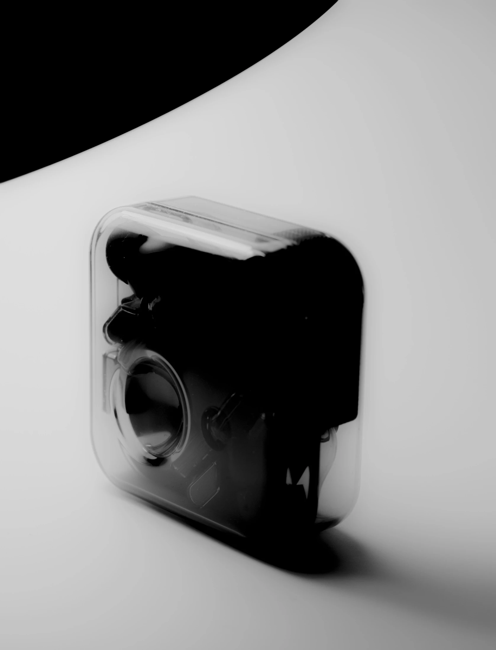 black and white pograph of the back of a camera with its reflection