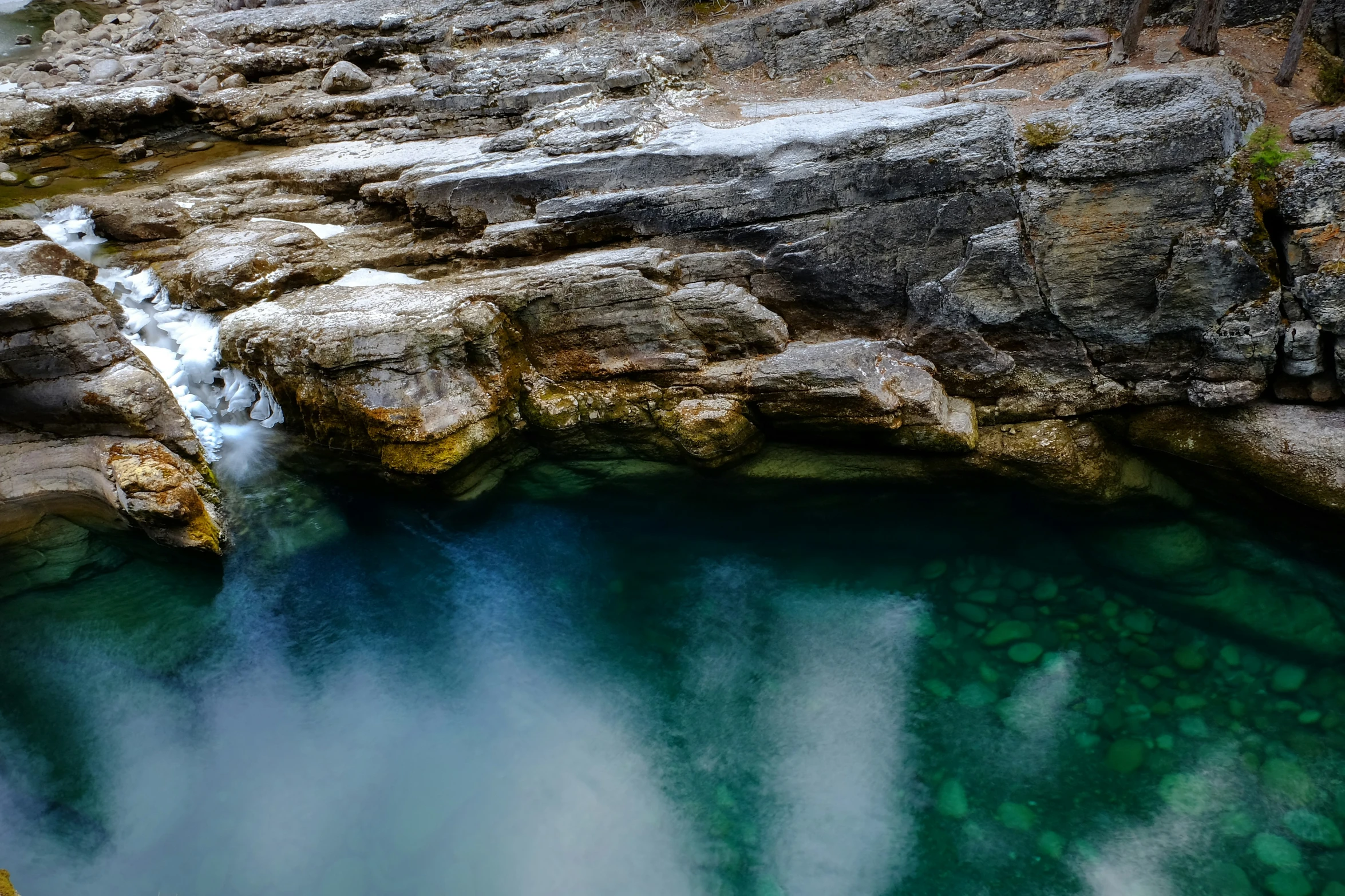 an aerial po of green water and waterfall