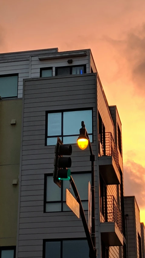 an orange light shines in the distance on a high rise building