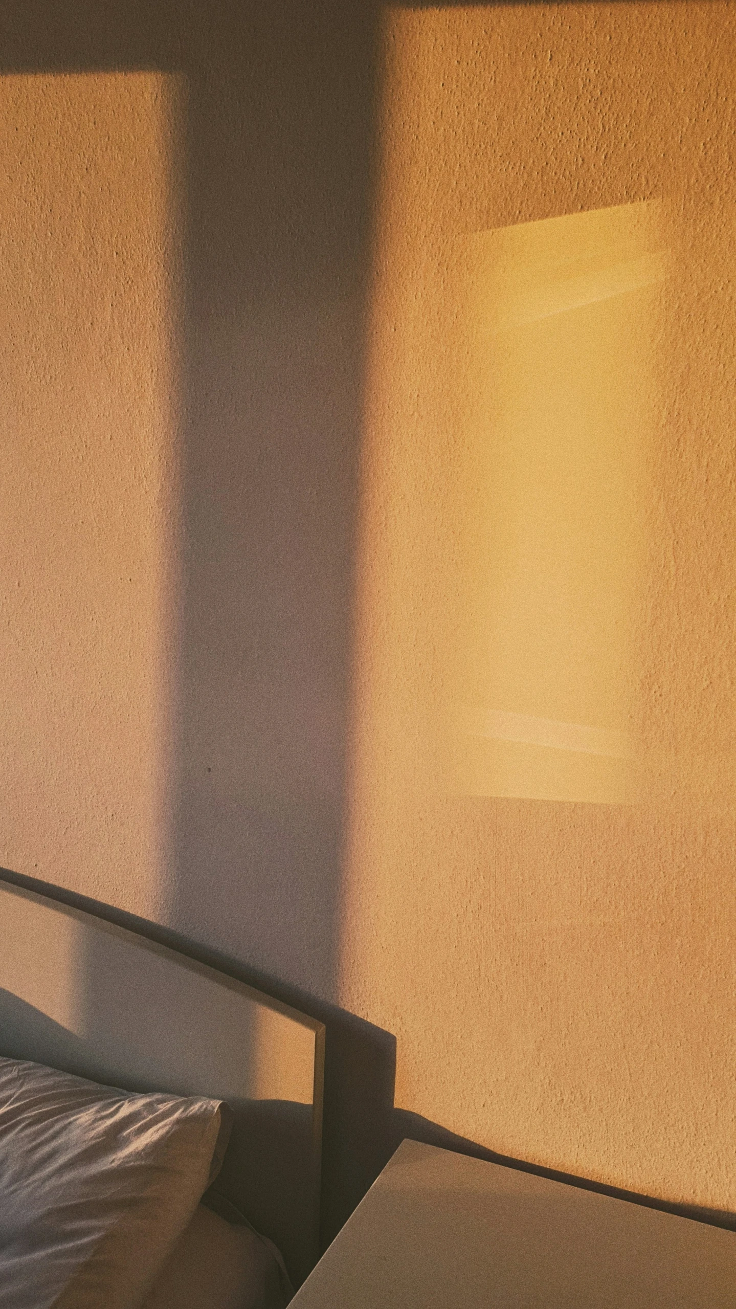 shadows cast on the wall and bed in a bedroom