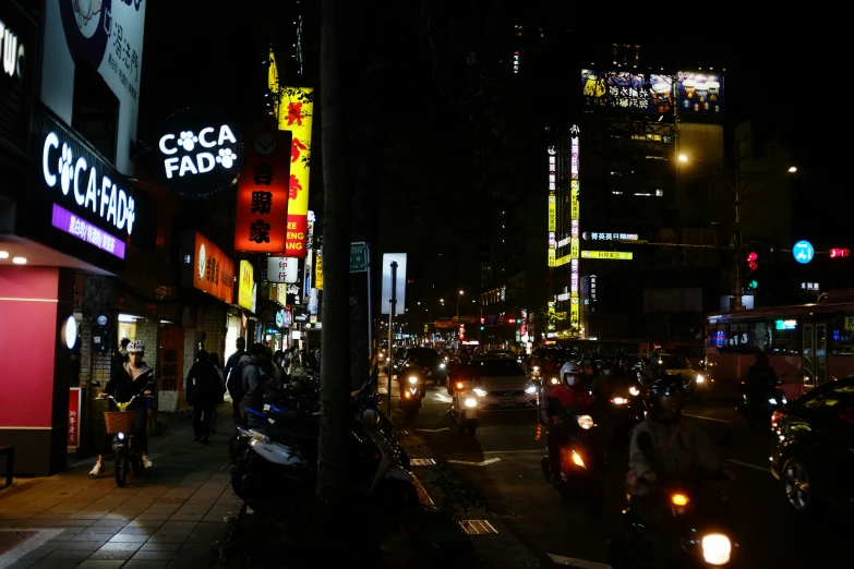 a large crowd of cars and people walk down the street