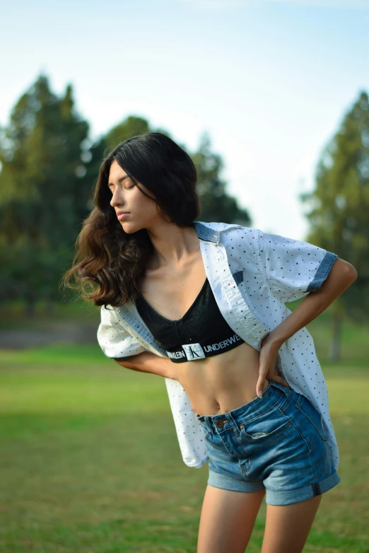 a girl with her back turned wearing a top