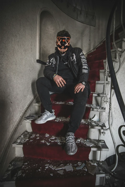 a man sitting on top of a stair case