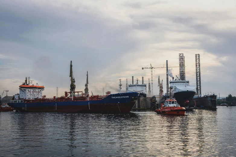 large boats docked in the water on cloudy day