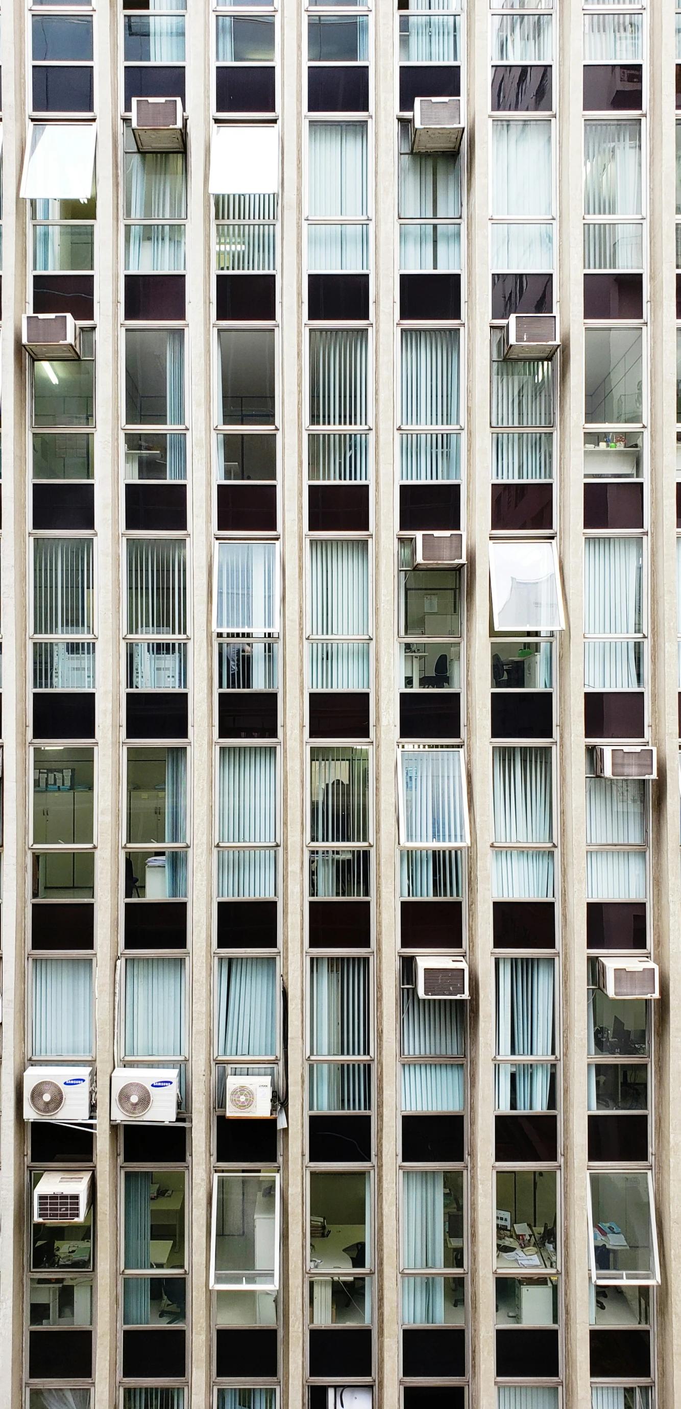 a building with multiple balconies in front of a blue sky