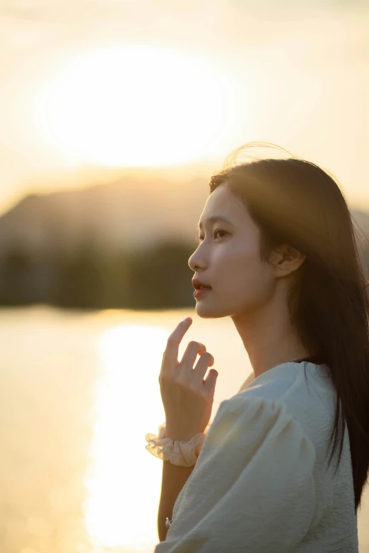 a woman with long hair and a ring on her finger