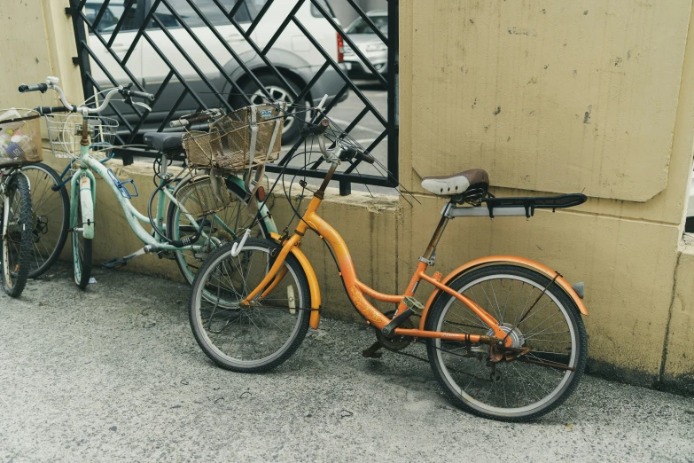 there are two bikes parked in front of the wall