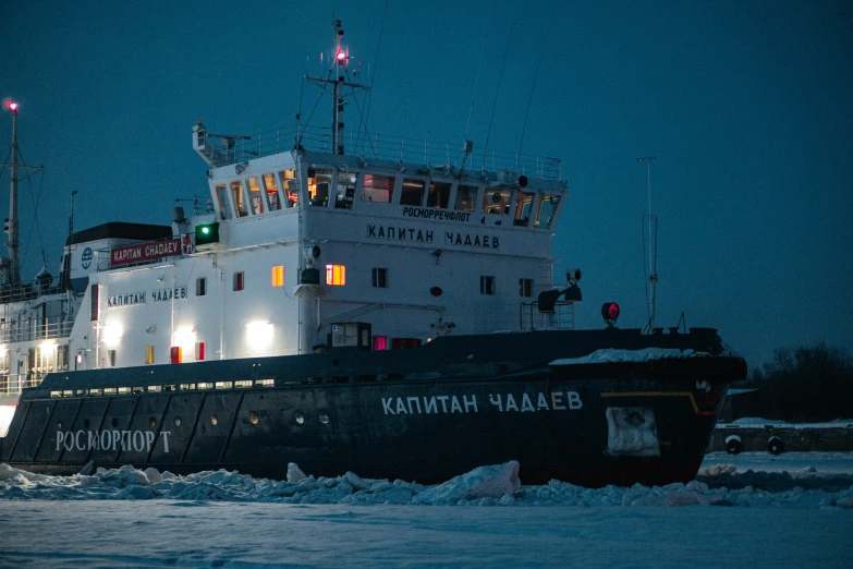 a boat traveling down the ice covered ocean