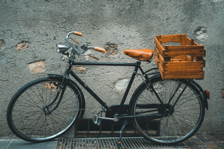 a bike with some wooden baskets parked near the street