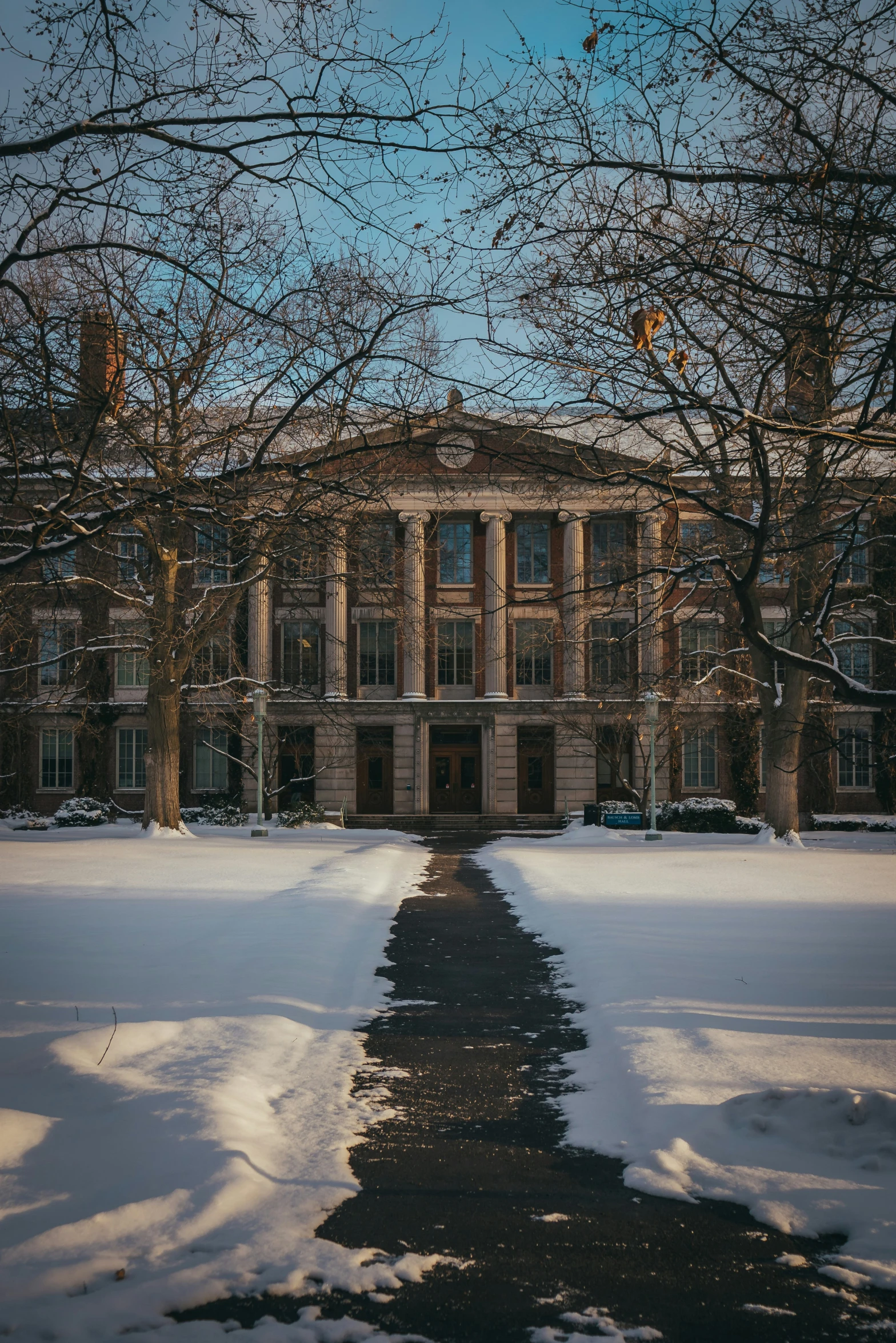 a long snow covered pathway that runs through a large building