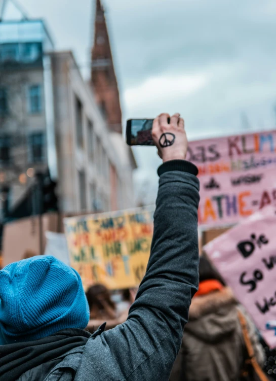 a woman holding her phone up in the air