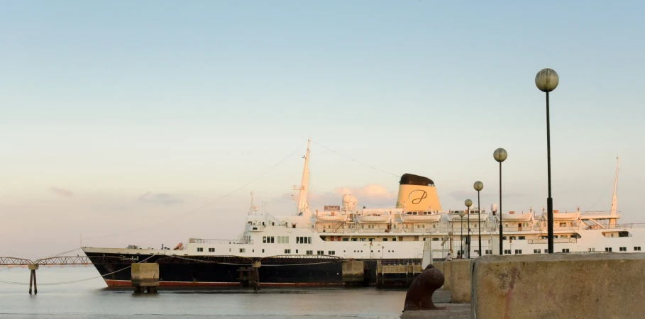 the boat is docked at the port by the pier