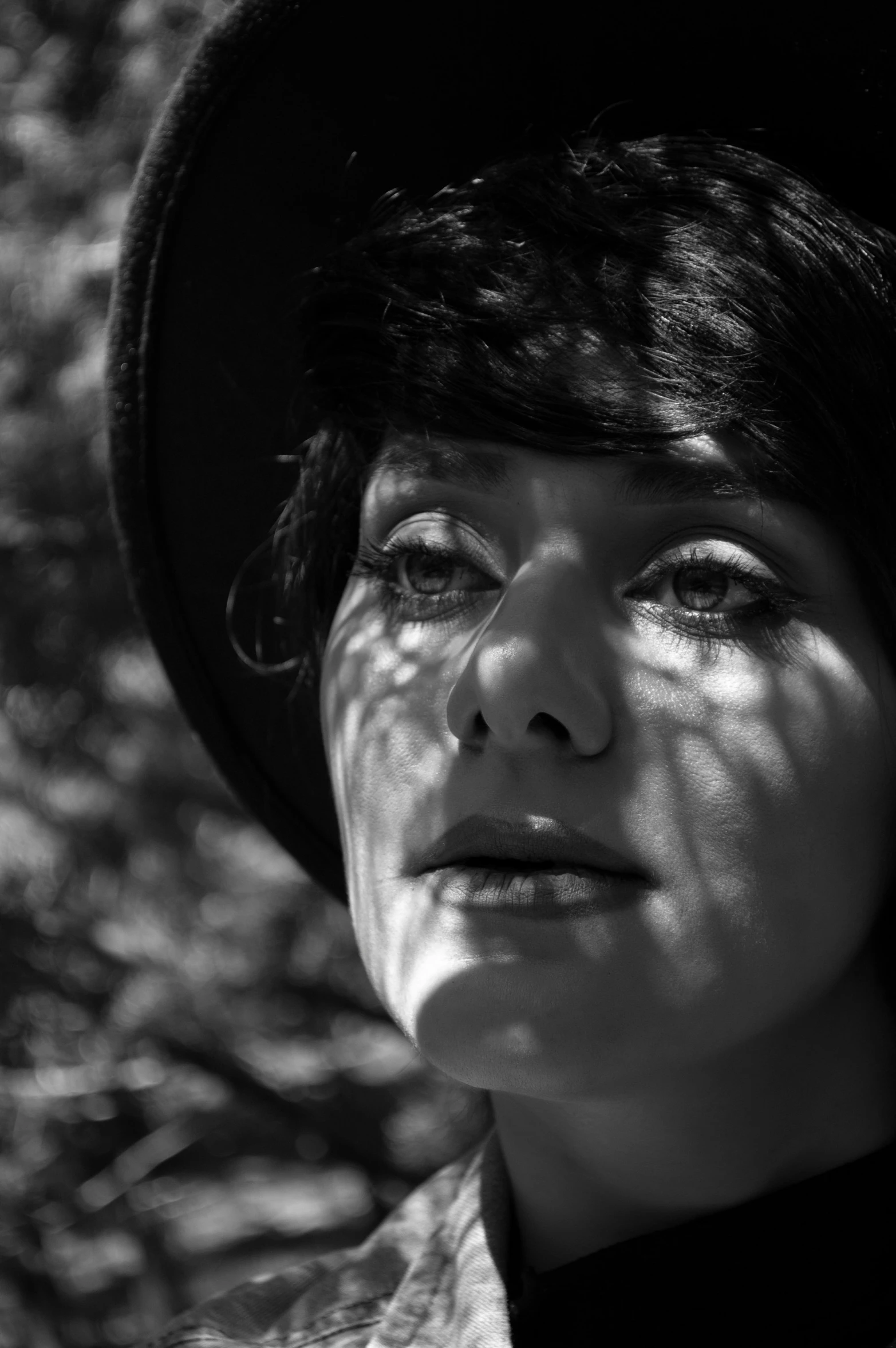 a black and white picture of a woman with a hat