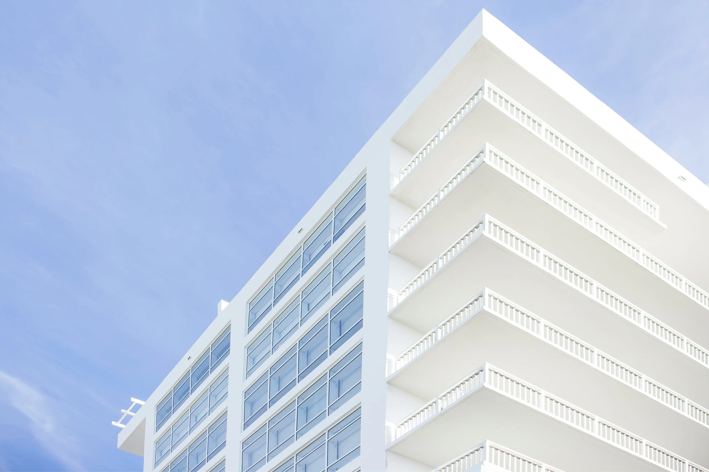 an apartment building is shown with white balconies