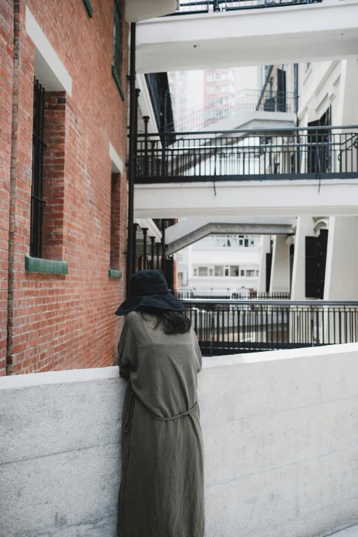 a woman standing outside of an apartment building