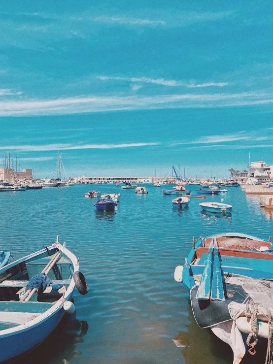 many different types and colors of boats anchored in the sea