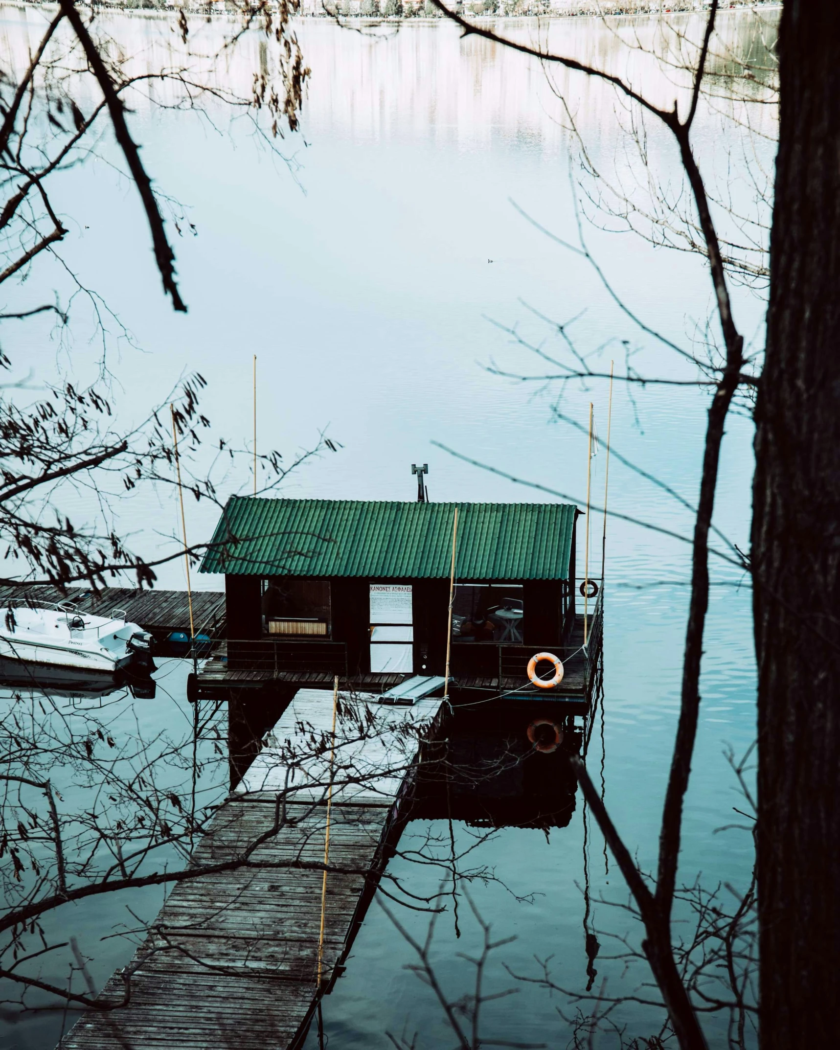 a dock with a green building on it's water