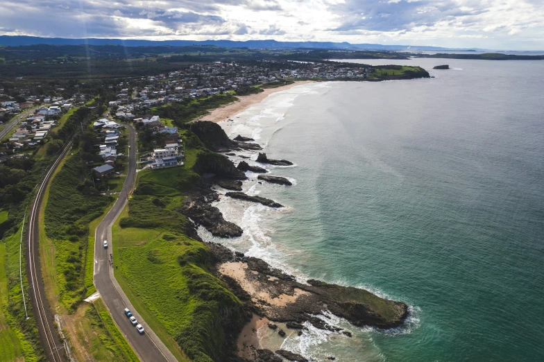 an aerial view of the sea and coastline next to the city