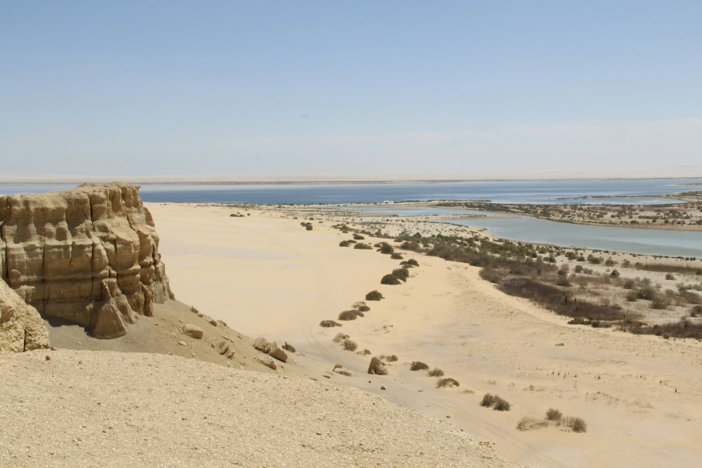 there is a large, large sand dune that overlooks the river and beach