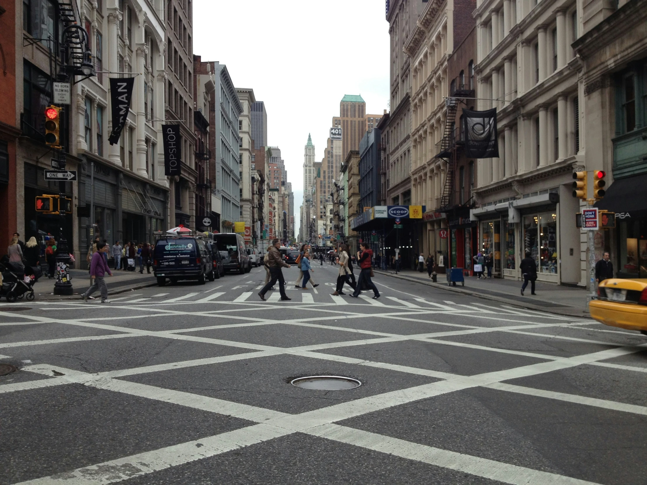 a bunch of people are crossing a busy street