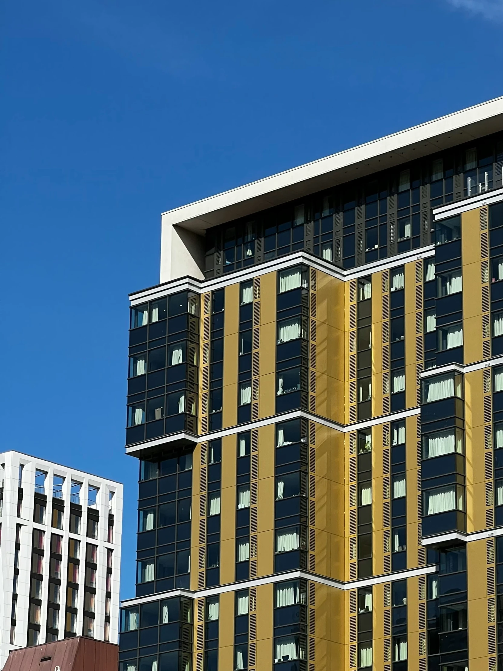 the top half of an office building is pictured from another other building