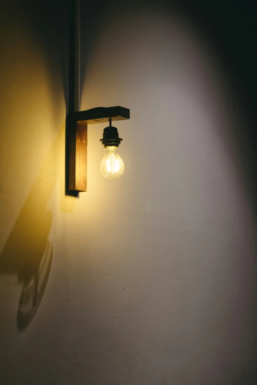 a light is lit on a wall with shadow