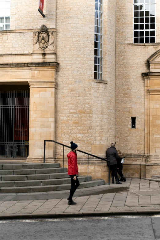 a man walking up some steps in front of some buildings