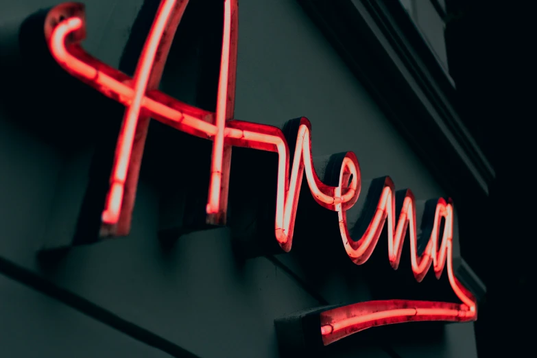 red neon sign with letters on the outside of the building