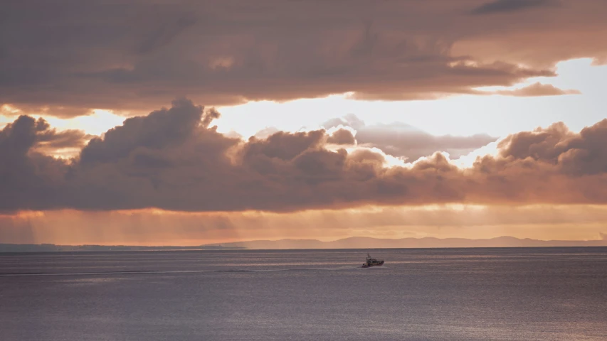 clouds are in the sky over the ocean