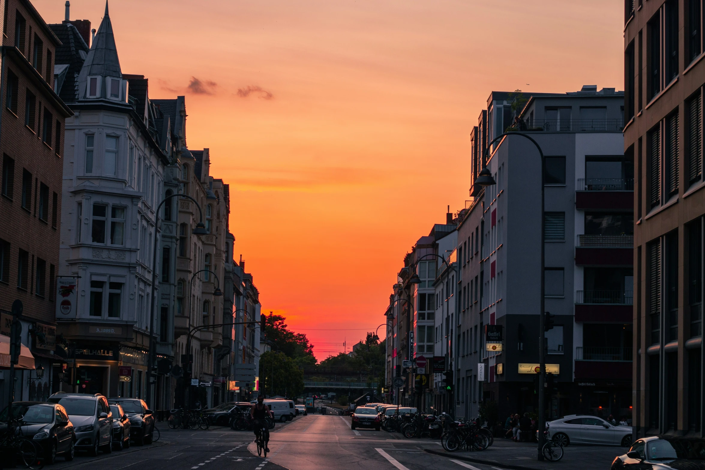 this is a view of a city street with sunset in the background