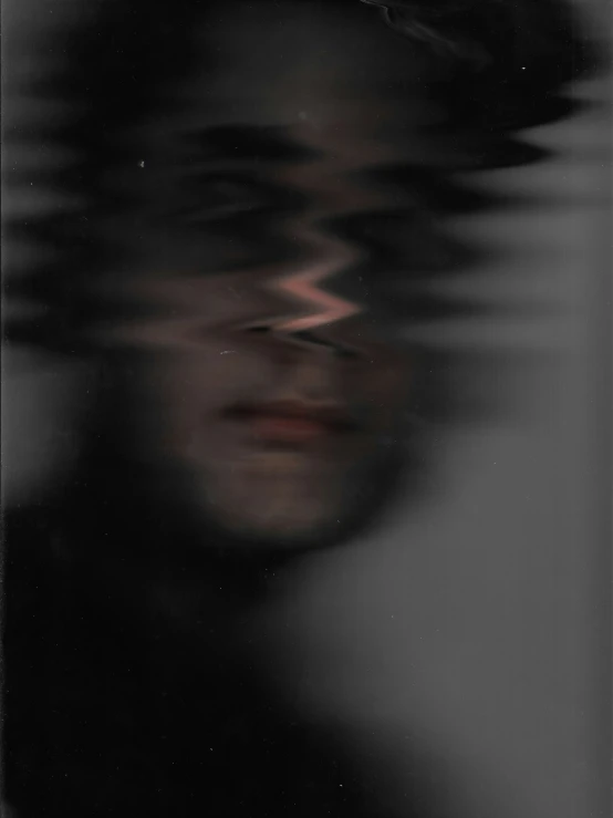 a blurry image of a person wearing a black hat