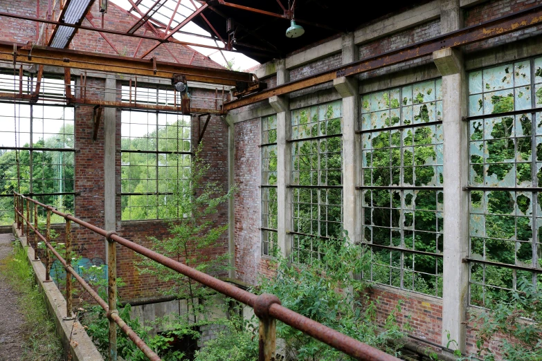 a brick building with multiple windows and a metal railing