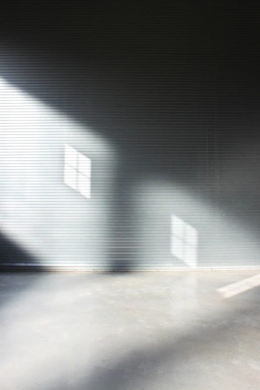 a large closed garage door with sunlight streaming through