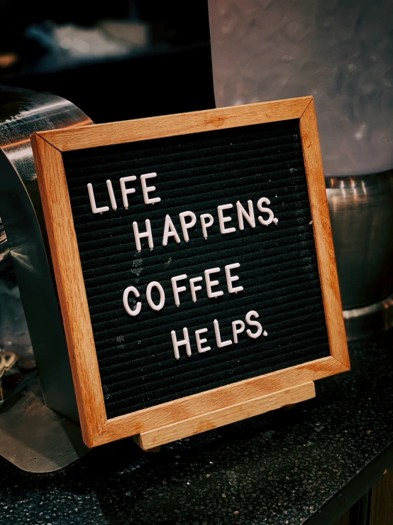 a sign that says life happens coffee helps