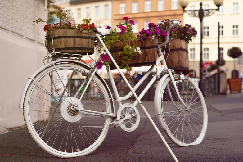 a bicycle decorated with flowers in front of a building