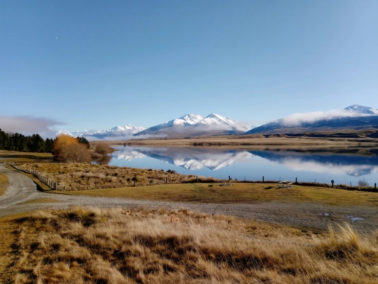 a large body of water sitting under a blue sky