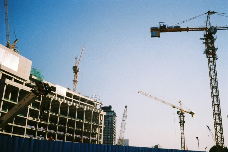 a crane standing in the air with some other cranes