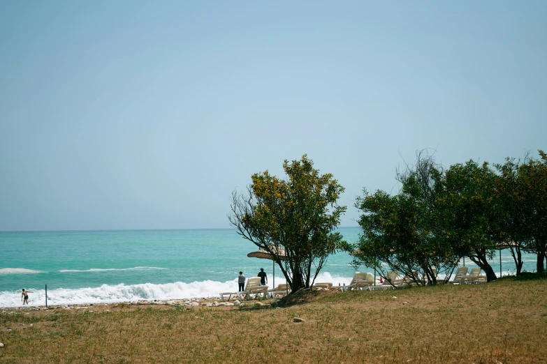 a couple of people that are standing on a beach