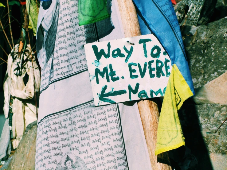 a street sign placed over the top of clothes