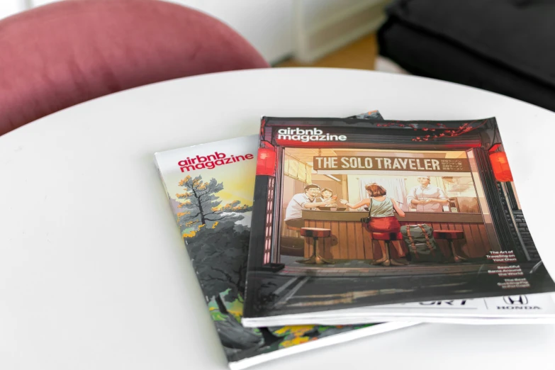 three magazine covers sitting on top of a white table