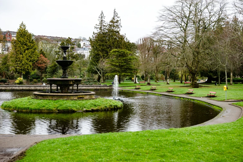 a small park near a pond in the middle of a park