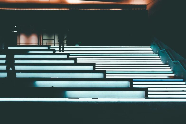 a man standing on top of some stairs at night