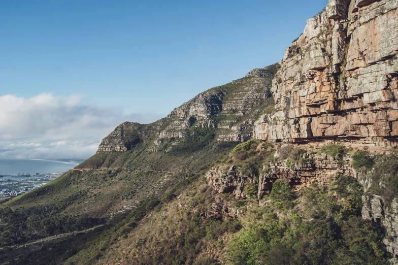 the top of a large mountain with trees on the side