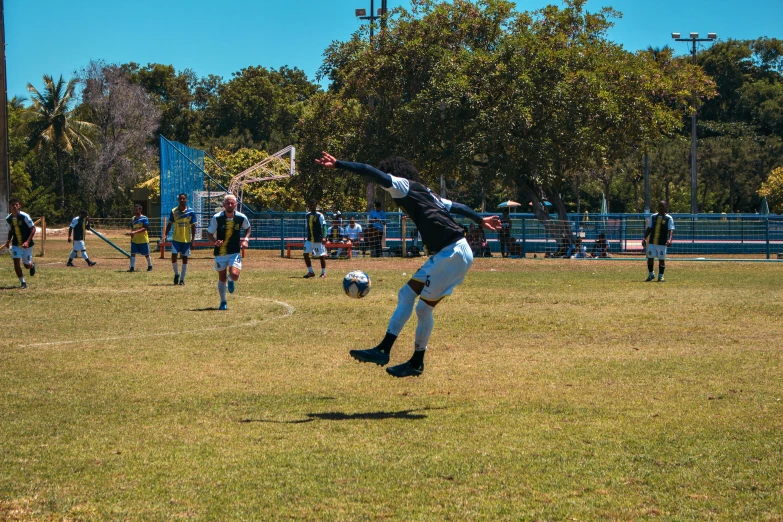 the man is playing with the soccer ball