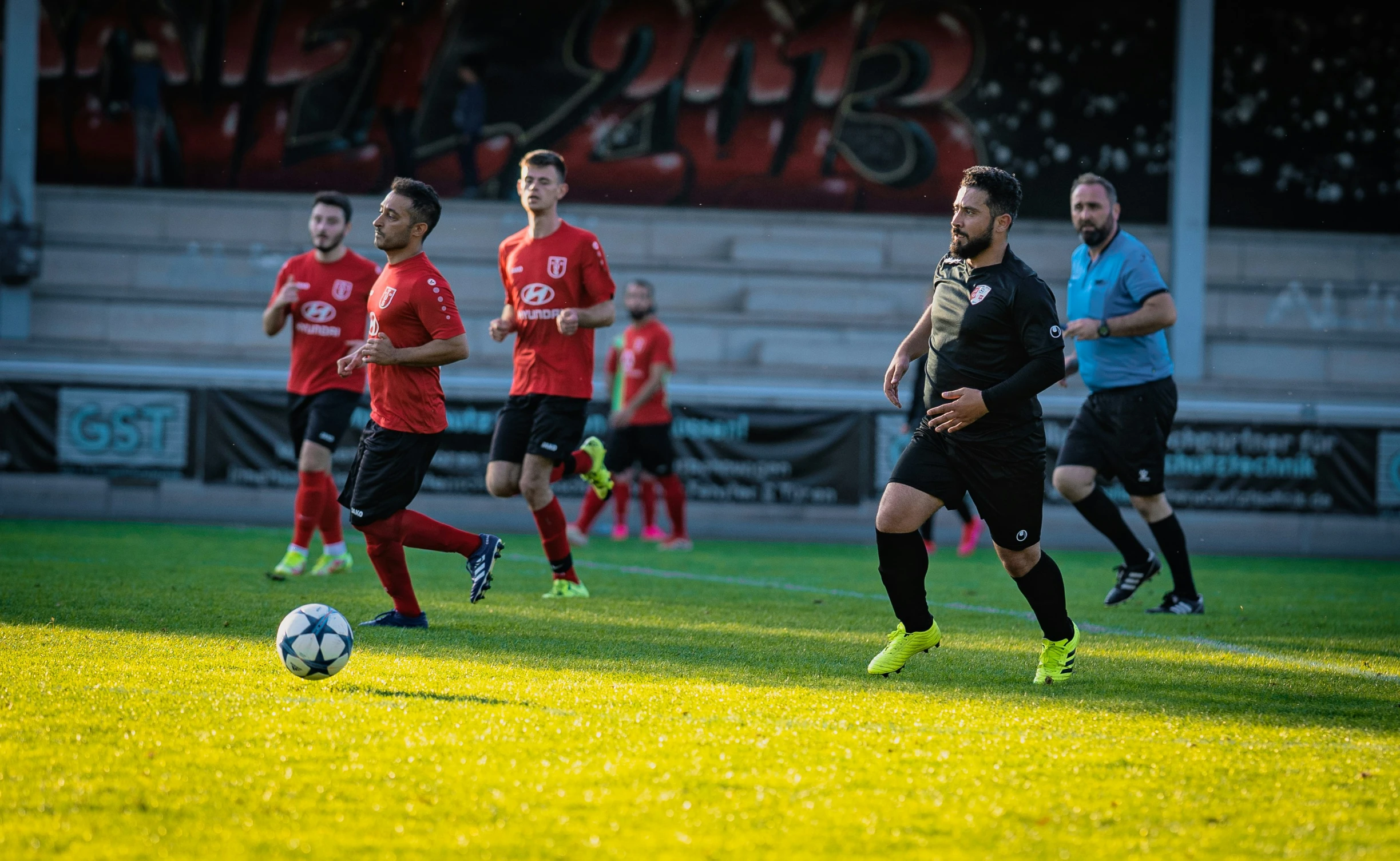 soccer players on a field playing in a game