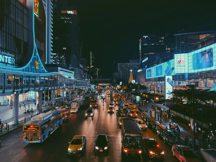 a city street filled with traffic at night