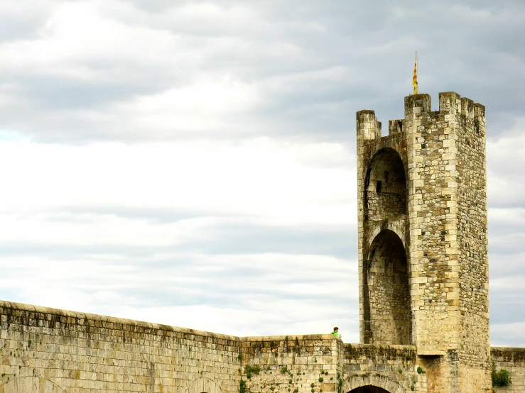 two towers against a gray cloudy sky